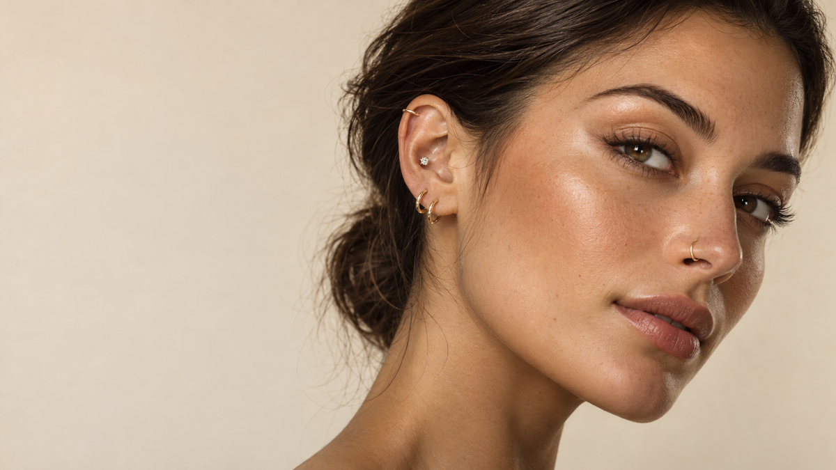 AI-generated editorial portrait with gold ear piercings and a delicate nostril hoop.